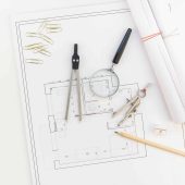 Creative flat lay overhead top view blueprints architectural flat project plan and office supplies on decorator square table workspace with swatches tools and equipment background copy space concept